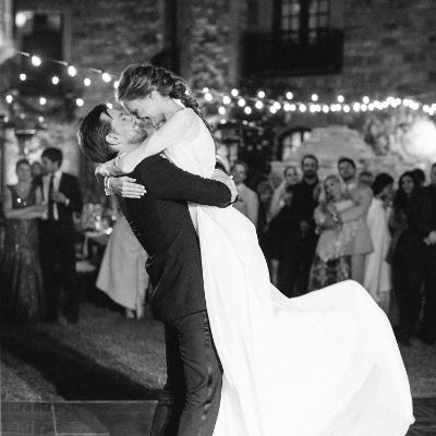 Torrance is holding Alyssa and lifting her up while her arms is surrounding him.